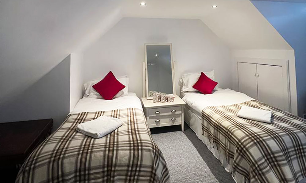 Single beds in bedroom at Colzium Edinburgh